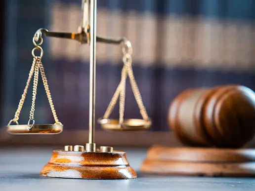 scales of justice and gavel sitting on a desk