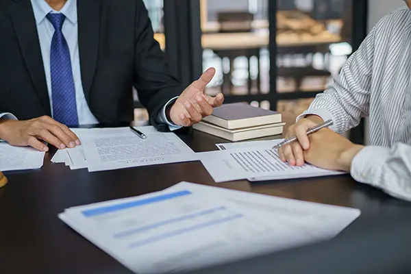 legal counsel presents a signed contract to a client