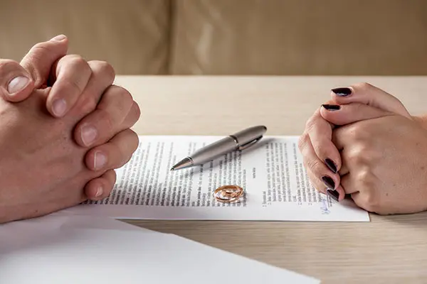 husband and wife signing premarital agreement document